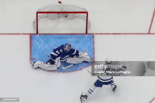 Goalie Andrei Vasilevskiy of the Tampa Bay Lightning makes a save against Auston Matthews of the Toronto Maple Leafs during the third period in Game...