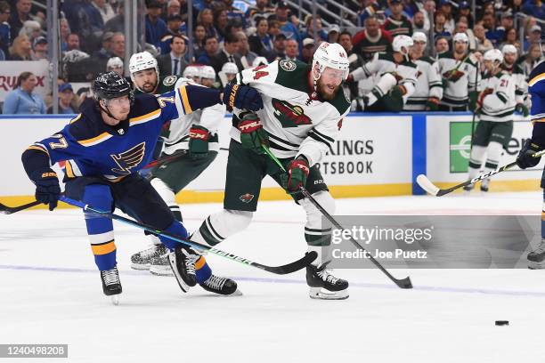 Niko Mikkola of the St. Louis Blues defends against Joel Eriksson Ek of the Minnesota Wild in Game Three of the First Round of the 2022 Stanley Cup...