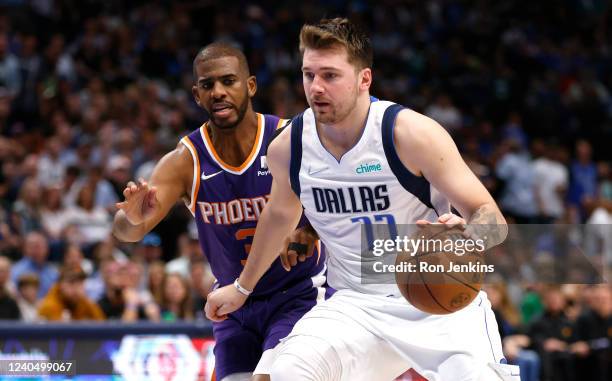 Luka Doncic of the Dallas Mavericks handles the ball as Chris Paul of the Phoenix Suns defends during the second half of Game Three of the 2022 NBA...