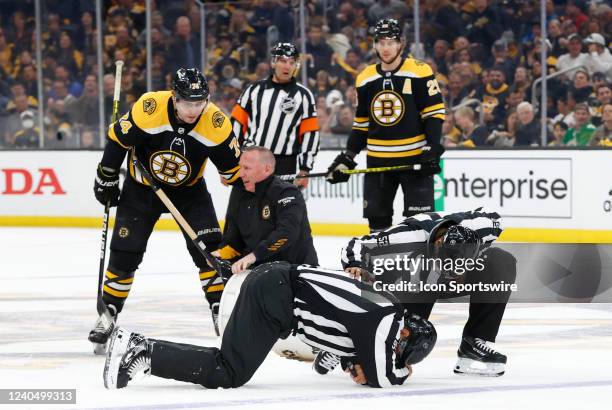 Linesman Jonny Murray is down after colliding with a TD Garden ice technician during Game 3 of the First Round NHL Stanley Cup Playoff series between...