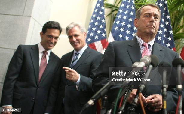 House Speaker John Boehner listens to questions from reporters as House Majority Leader Eric Cantor and House Majority Whip Kevin McCarthy look on...