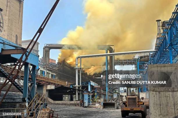 Plume of yellow smoke billows at a Coke plant after a fire broke out a Tata steel factory in Jamshedpur on May 7, 2022.