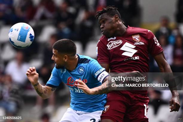 Napoli's Italian forward Lorenzo Insigne and Torino's Ivorian defender Wilfried Singo go for a header during the Italian Serie A football match...