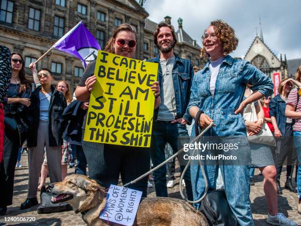 People are holding placards in support of women rights, during a demonstration in solidarity for the right to abortion in the USA, organized in...