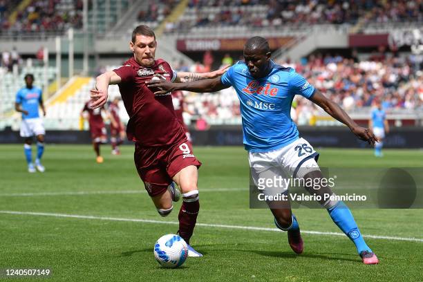 Andrea Belotti of Torino FC is challenged by Kalidou Koulibaly of SSC Napoli during the Serie A match between Torino FC and SSC Napoli at Stadio...