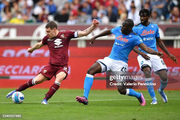 Andrea Belotti of Torino FC is challenged by Kalidou Koulibaly of SSC Napoli during the Serie A match between Torino FC and SSC Napoli at Stadio...