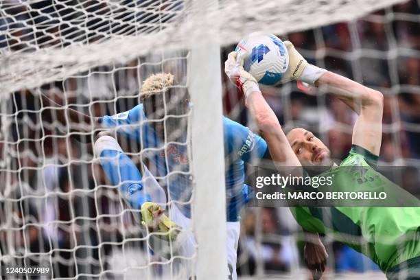 Torino's Albanian goalkeeper Etrit Berisha grabs the ball under pressure from Napoli's Nigerian forward Victor Osimhen during the Italian Serie A...