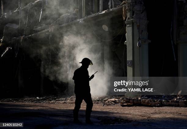 Rescuer walks near debris of the Saratoga Hotel, in Havana, on May 7, 2022. - The death toll after an explosion ripped through a luxury hotel in...