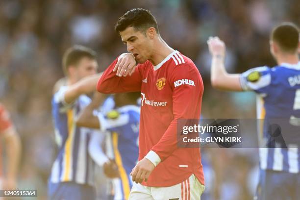 Manchester United's Portuguese striker Cristiano Ronaldo reacts on the pitch after the English Premier League football match between Brighton and...