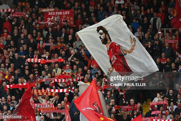 Liverpool fans waves flags in the crowd ahead of the English Premier League football match between Liverpool and Tottenham Hotspur at Anfield in...