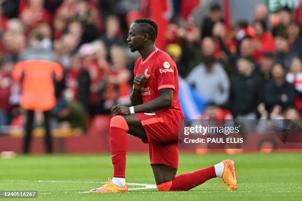 Liverpool's Senegalese striker Sadio Mane takes a knee in support of the Premier League's No Room For Racism campaign ahead of the English Premier...