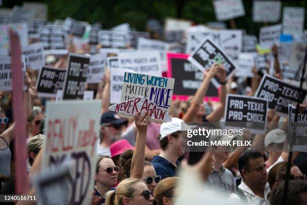 Attendees hold up signs during A Texas Rally for Abortion Rights at Discovery Green in Houston, Texas, on May 7, 2022. - Multiple US organizations...
