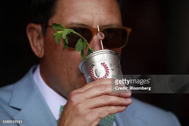 An attendee drinks a Woodford Reserve $1000 mint julep before the 148th running of The Kentucky Derby at Churchill Downs in Louisville, Kentucky,...