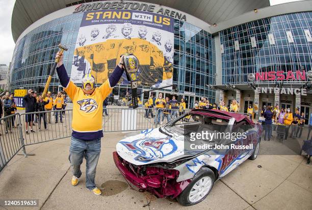 Nashville Predators fans smash the Avalanche Car prior to Game Three of the First Round of the 2022 Stanley Cup Playoffs against the Colorado...
