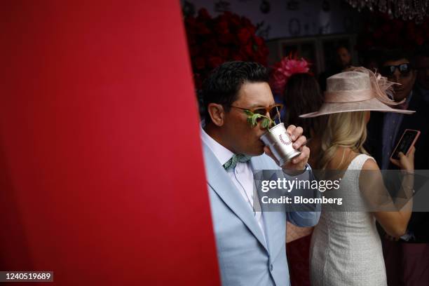 An attendee drinks a Woodford Reserve $1000 mint julep before the 148th running of The Kentucky Derby at Churchill Downs in Louisville, Kentucky,...