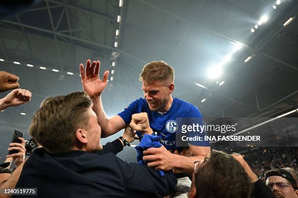 Schalke's German striker Simon Terodde celebrates on the pitch after the German second division Bundesliga football match between FC Schalke 04 vs...