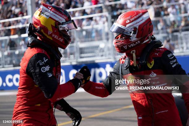 Ferrari's Spanish driver Carlos Sainz , who finished second, is congratulated by teammate Monegasque driver Charles Leclerc, who took the pole...