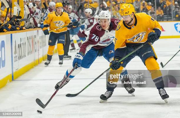Alexandre Carrier of the Nashville Predators battles for the puck against Nico Sturm of the Colorado Avalanche in Game Three of the First Round of...