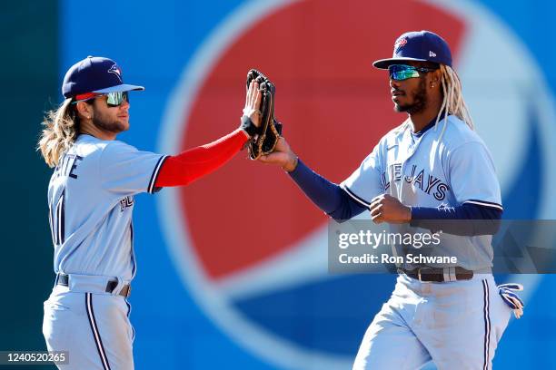 Bo Bichette and Raimel Tapia of the Toronto Blue Jays celebrate an 8-3 win against the Cleveland Guardians in game one of a doubleheader at...