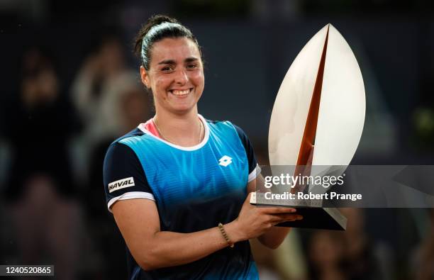 Ons Jabeur of Tunisia poses with the champions trophy after defeating Jessica Pegula of the United States in the womens singles final match on Day 10...