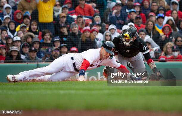 Trevor Story of the Boston Red Sox tagged out at home plate by Yasmani Grandal of the Chicago White Sox during the fifth inning at Fenway Park on May...