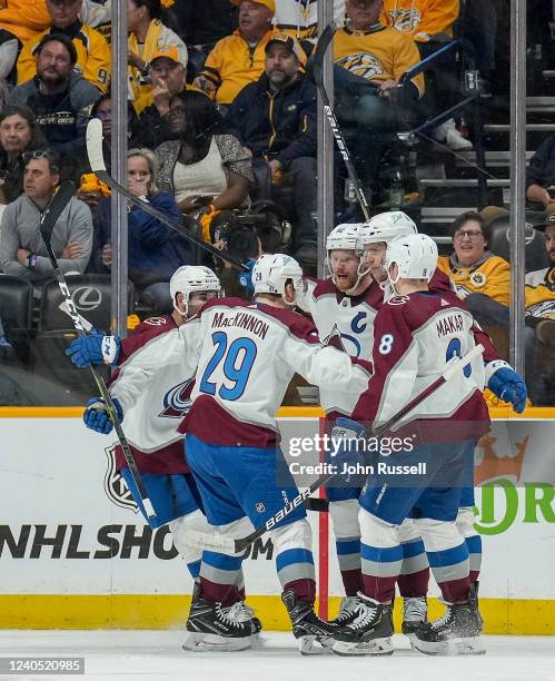 Gabriel Landeskog of the Colorado Avalanche celebrates his goal with Nathan MacKinnon and Cale Makar against the Nashville Predators in Game Three of...