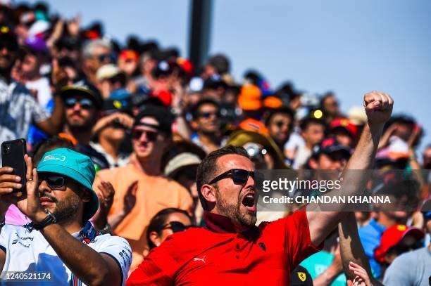 Ferrari fans cheer during qualifying for the Miami Formula One Grand Prix at the Miami International Autodrome in Miami Gardens, Florida, on May 7,...