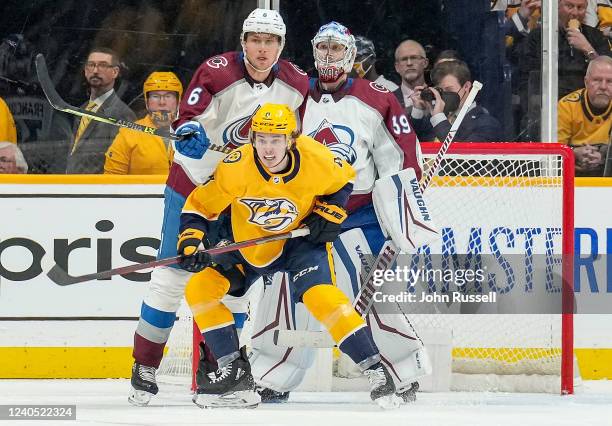 Cody Glass of the Nashville Predators battles in front of the net against Erik Johnson and Pavel Francouz of the Colorado Avalanche in Game Three of...