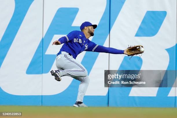 Lourdes Gurriel of the Toronto Blue Jays makes a running catch on a ball off the bat of Oscar Mercado of the Cleveland Guardians in the seventh...