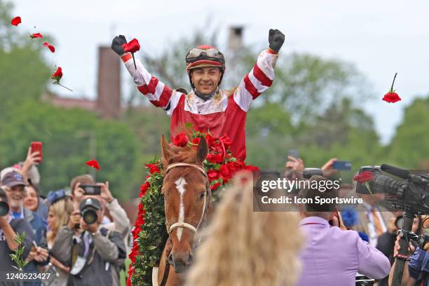 Jockey Sonny Leon aboard Rich Strike tosses roses in the winner's circle after winning the148th running of the Kentucky Derby on May 7th at Churchill...