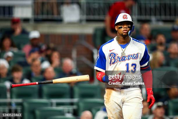 Ronald Acuña Jr. #13 of the Atlanta Braves flips his bat after a walk in the seventh inning of a game against the Milwaukee Brewers at Truist Park on...