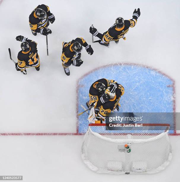 Louis Domingue of the Pittsburgh Penguins is hugged by Jake Guentzel after a 7-4 win over the New York Rangers in Game Three of the First Round of...