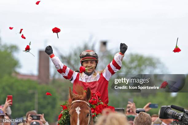 Jockey Sonny Leon aboard Rich Strike tosses roses in the winner's circle after winning the148th running of the Kentucky Derby on May 7th at Churchill...