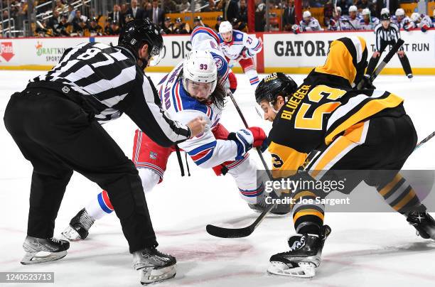 Mika Zibanejad of the New York Rangers takes a face-off against Teddy Blueger of the Pittsburgh Penguins in Game Three of the First Round of the 2022...