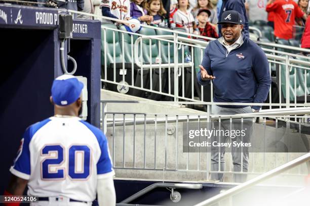 Former Atlanta Braves center fielder Andruw Jones talks with Marcell Ozuna of the Atlanta Braves after a game against the Milwaukee Brewers at Truist...