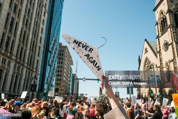 Protesters hold placards, chant, and march through downtown Detroit in support of Roe v Wade. Pro-choice activists march through the streets of...