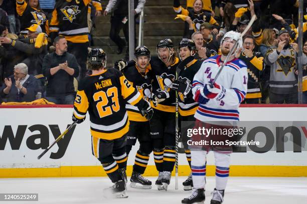 Pittsburgh Penguins center Jeff Carter celebrates his goal with teammates as New York Rangers left wing Alexis Lafrenière reacts during the third...