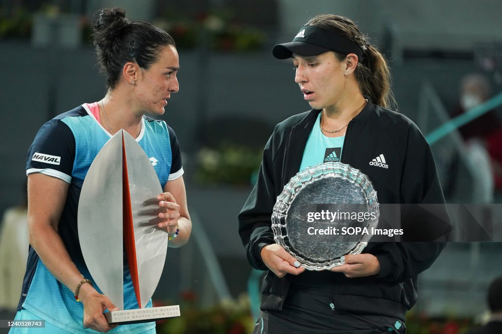 Ons Jabeur (L) of Tunisia celebrates with a trophy and...