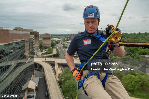 Chairman of the Fairfax County Board of Supervisors Jeff McKay begins to rappel from the roof of the Crystal City Hilton in Arlington, VA on May 05,...