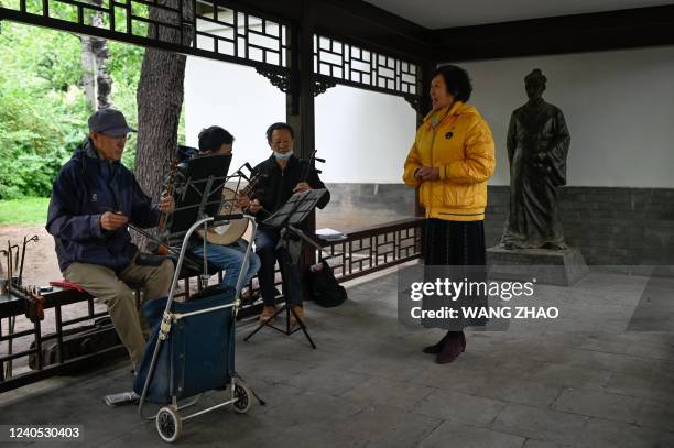 Group of people practice Peking Opera at a park in Beijing on May 8, 2022.