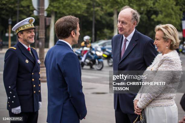 France's President Emmanuel Macron speaks with Yves de Gaulle , a grand-son of Charles de Gaulle and his wife Laurence de Gaulle near the Arc de...