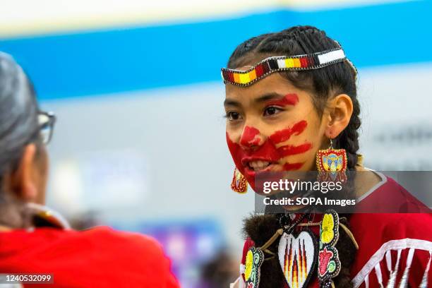 Dancer asks a family member to check her teeth for red marks. The hand print is used as a symbol to show solidarity with missing and murdered...