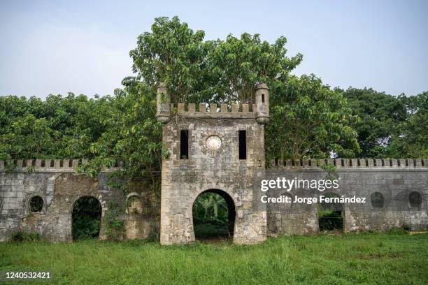 Old fortification of the Roça Sundi colonial plantation eaten by jungle vegetation.