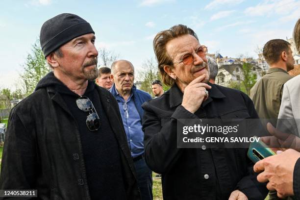 Bono , activist and front man of the Irish rock band U2 and guitarist David Howell Evans aka 'The Edge' visits the site of a mass grave by the Church...