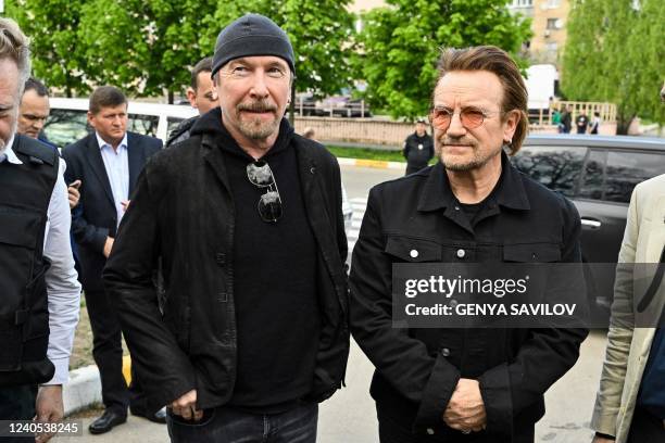 Bono , activist and front man of the Irish rock band U2 and guitarist David Howell Evans aka 'The Edge' visits the site of a mass grave by the Church...