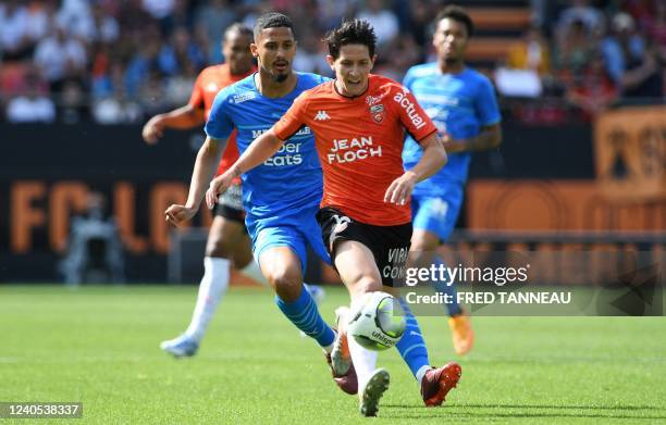 Lorient's French midfielder Laurent Abergel fights for the ball with Marseille's French defender William Saliba during the French L1 football match...