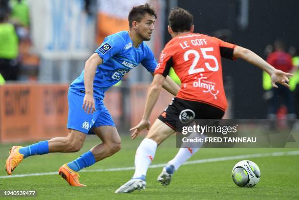 Lorient's French defender Vincent Le Goff fights for the ball with Marseille's French midfielder Valentin Rongier during the French L1 football match...
