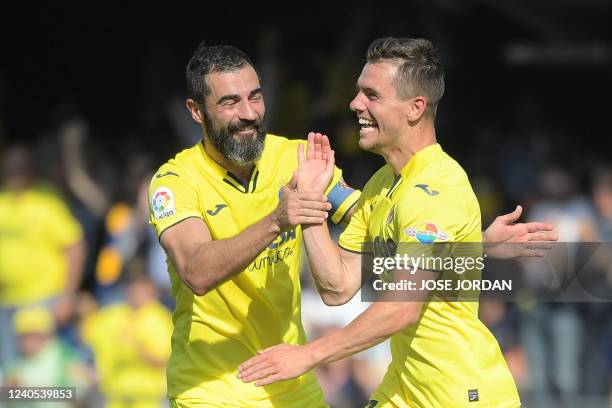 Villarreal's Argentinian midfielder Giovani Lo Celso celebrates with teammate Villarreal's Spanish defender Raul Albiol after scoring a goal during...
