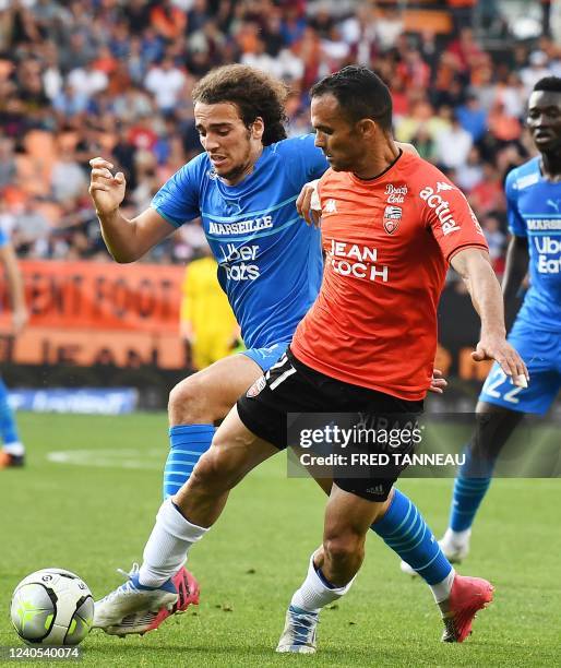 Lorient's Malagasy defender Jeremy Morel fights for the ball with Marseille's French midfielder Matteo Guendouzi during the French L1 football match...