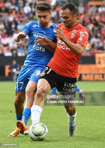 Lorient's Malagasy defender Jeremy Morel fights for the ball with Marseille's Turkish forward Cengiz Under during the French L1 football match...